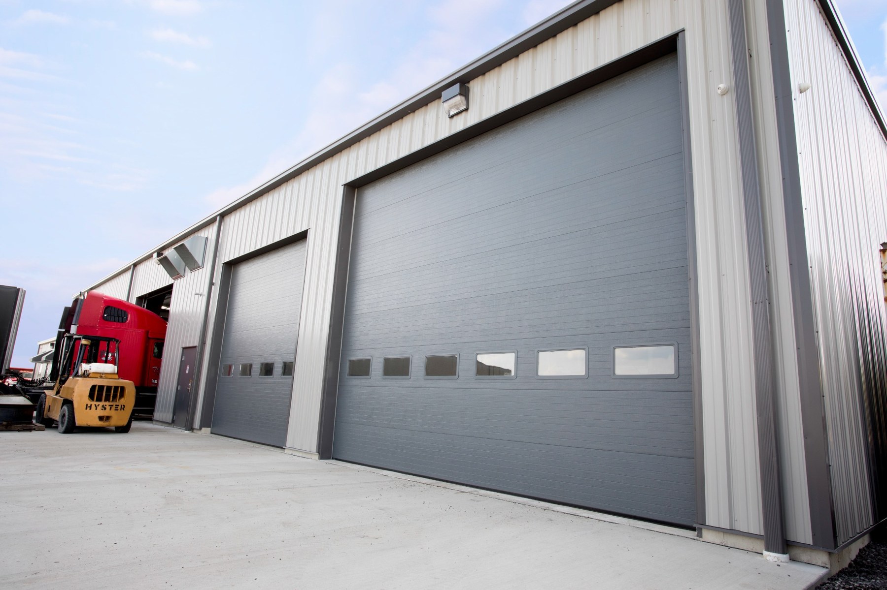 Charcoal Flush Panel Commercial Doors With Windows on a Multi-Bay Building